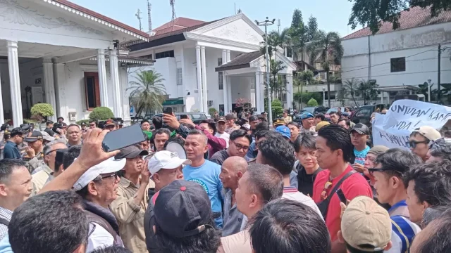 Massa pedagang Pasar Bogor memadati halaman Balaikota dalam aksi penolakan rencana pembangunan pasar baru.